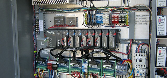 Organized electrical access control panel with colored wiring, labeled components, and circuit boards.