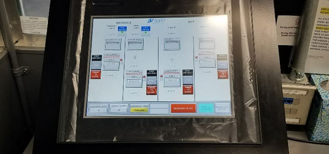 Touchscreen control interface with various status indicators and operational buttons.