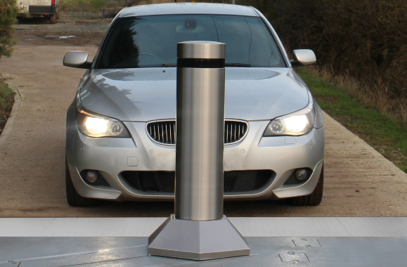 Vehicle parked in front of a sturdy bollard designed for traffic control.